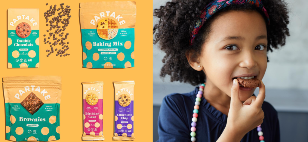 An image showing a young African American girl happily eating a cookie from Partake Foods. Beside her are various Partake Foods products, including snack packs and cookie boxes, reflecting the brand's dedication to providing delicious and allergen-friendly treats for everyone to enjoy.