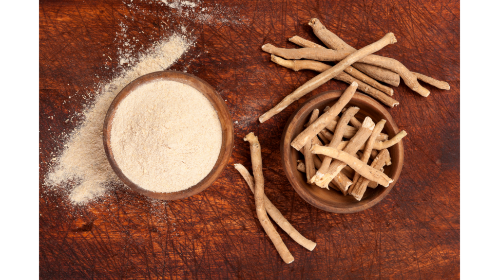 An image of Ashwagandha root and powder displayed on a wooden table. The Ashwagandha root is placed in a wooden bowl, while the powder is in a separate wooden bowl nearby. The earthy tones of the wooden table and bowls complement the natural appearance of the Ashwagandha, creating a serene and rustic setting.