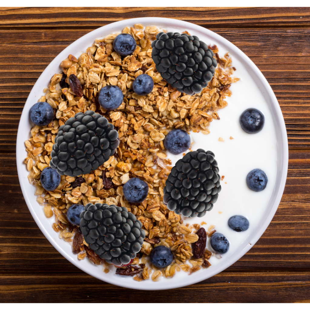 Bowl of yogurt topped with buckwheat granola and berries